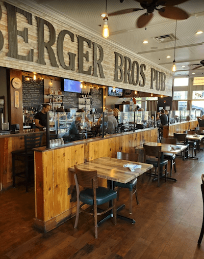 The bar at Berger Bros. Pub beneath the large Berger Bros. Pub wall sign